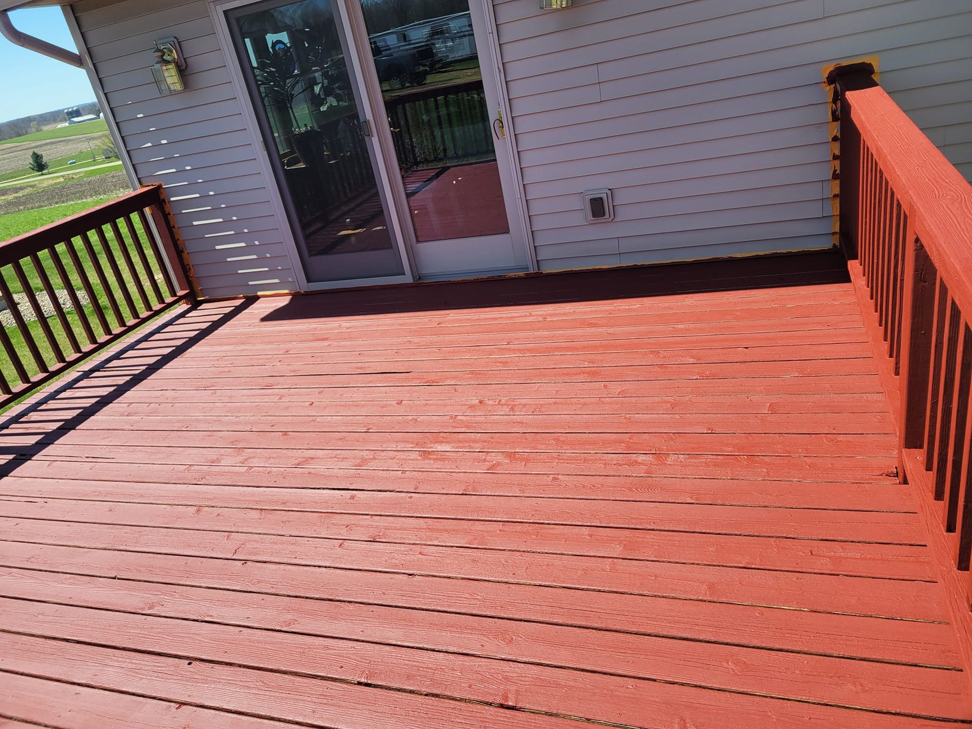 A Red Deck With A White House In The Background – Cottage Grove, MN - Minnesota Nice Painting