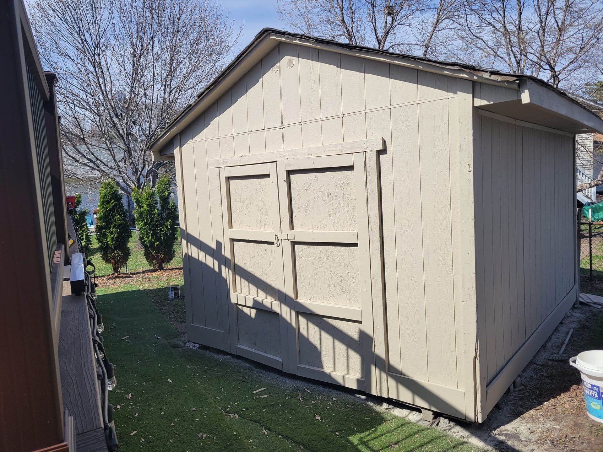 A Small White Shed Is Sitting On Top Of A Lush Green Field – Cottage Grove, MN - Minnesota Nice Painting
