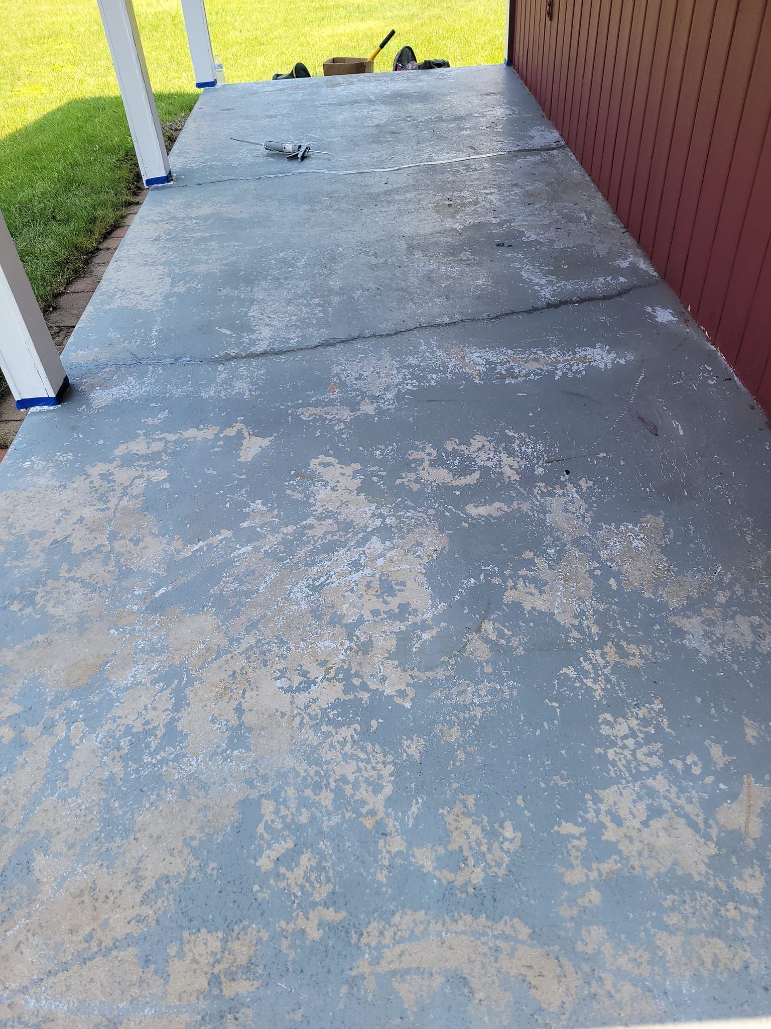 A Dirty Concrete Porch With A Red Wall In The Background – Cottage Grove, MN - Minnesota Nice Painting