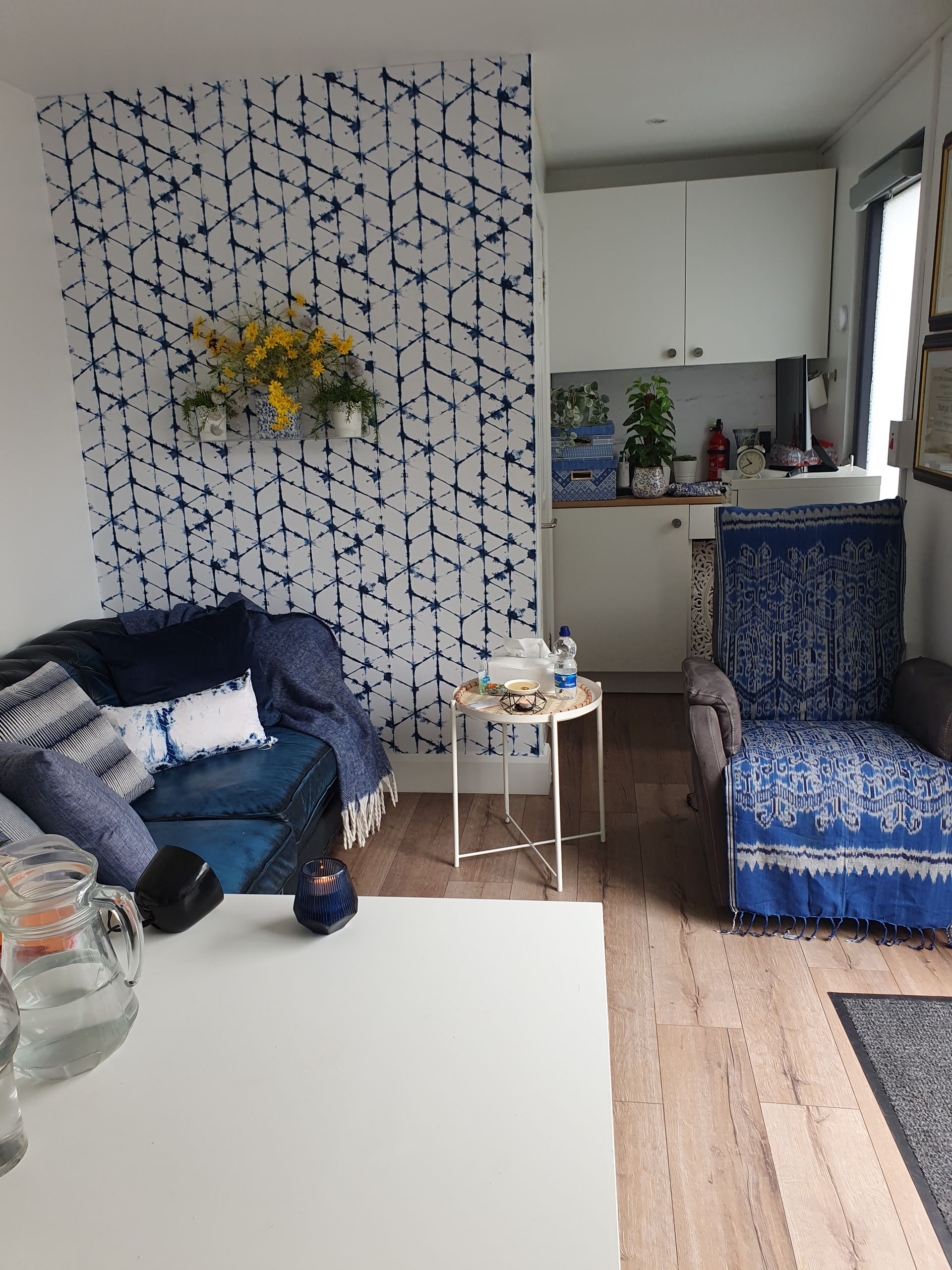 A living room with a couch , chair and table.