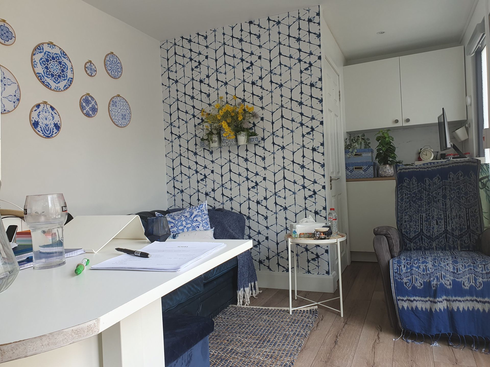 A living room with blue and white plates on the wall