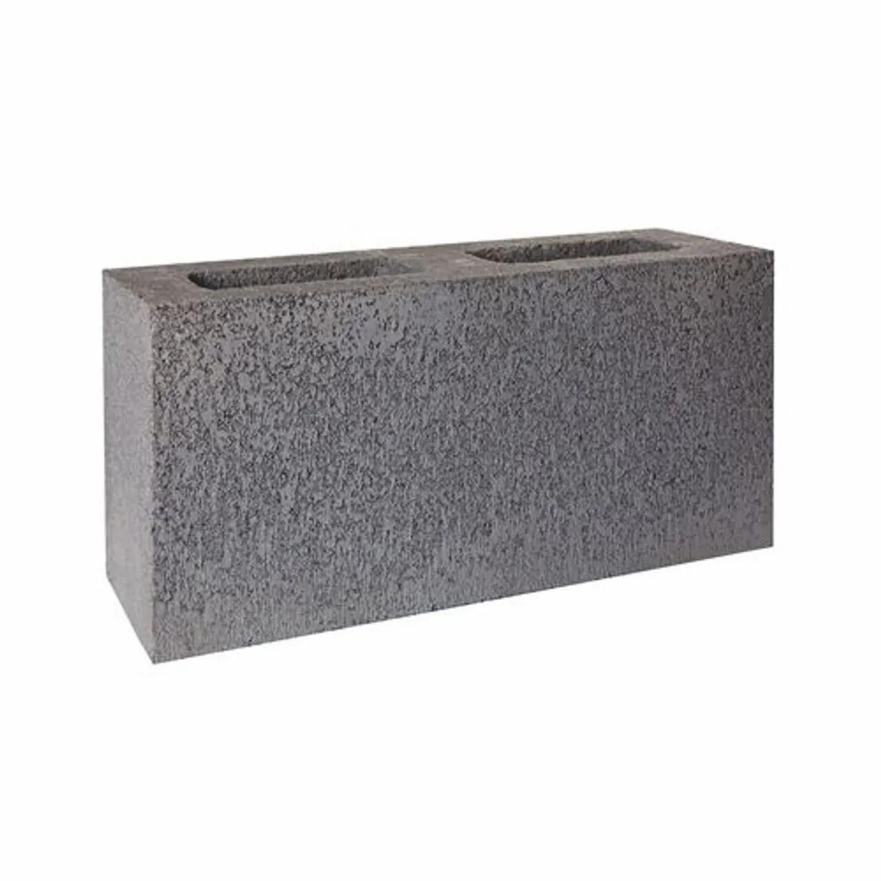 A Gray Concrete Block With Two Holes In It On A White Background — Campbell's Truck and Bobcat and Landscape Supplies In Gympie, QLD
