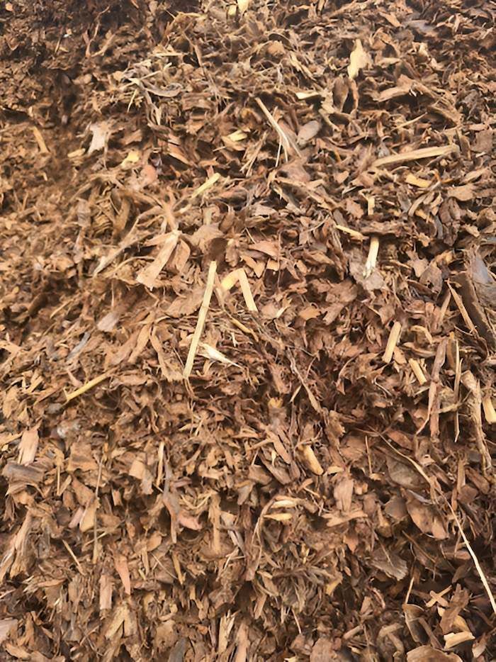 A Pile of Brown Mulch is Sitting on the Ground — Campbell's Truck and Bobcat and Landscape Supplies In Gympie, QLD