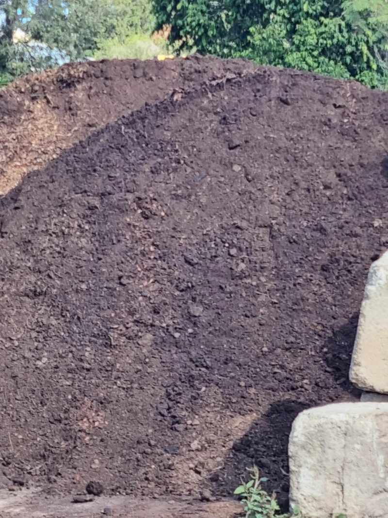 A Pile Of Dirt Is Sitting On Top Of A Hill — Campbell's Truck and Bobcat and Landscape Supplies In Gympie, QLD