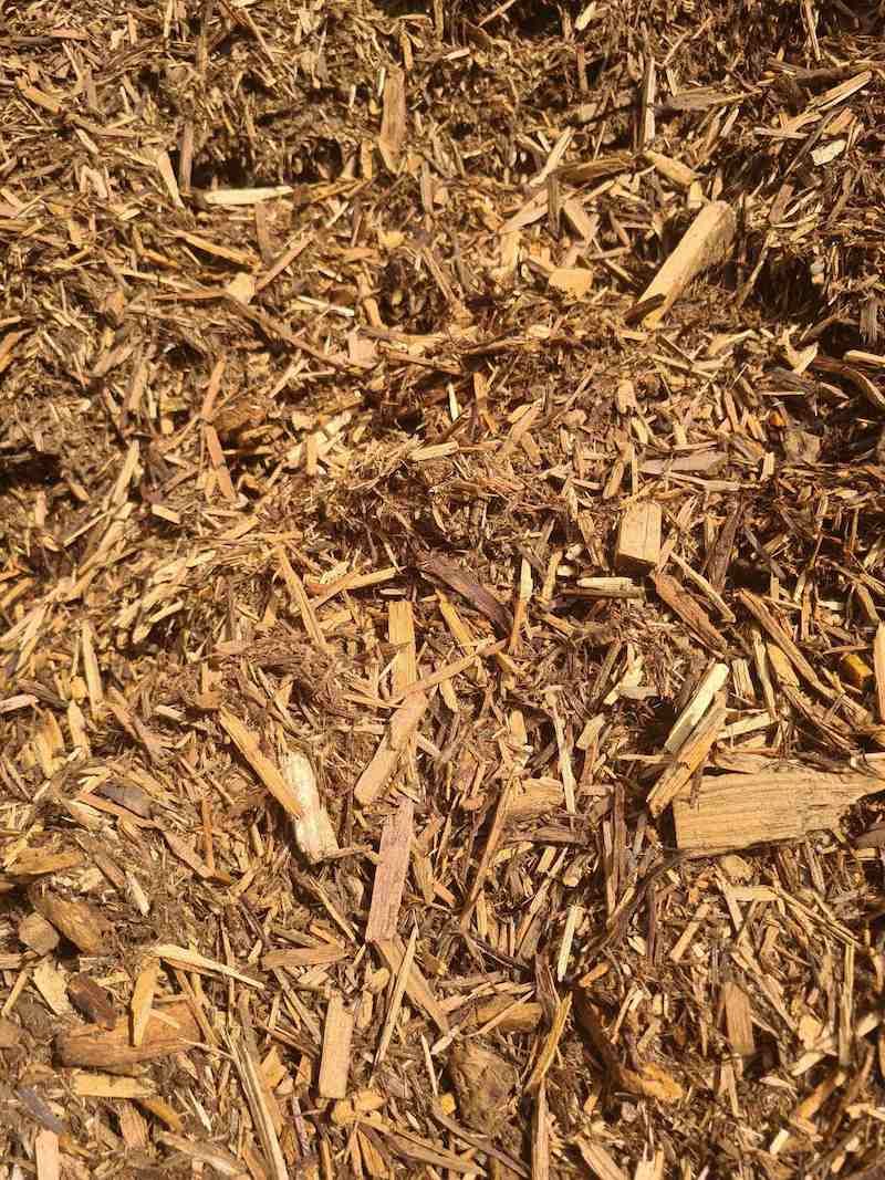 A Pile Of Wood Chips Is Sitting On The Ground — Campbell's Truck and Bobcat and Landscape Supplies In Gympie, QLD