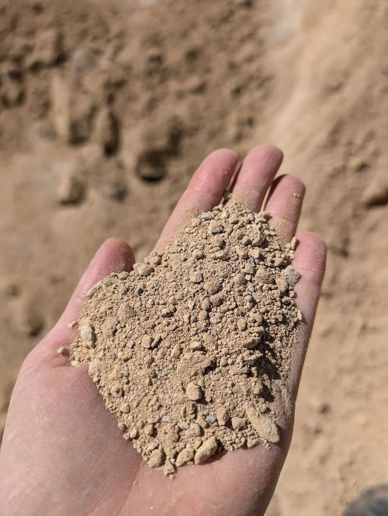A Person Is Holding A Pile Of Decomposed Sandstone — Campbell's Truck and Bobcat and Landscape Supplies In Gympie, QLD
