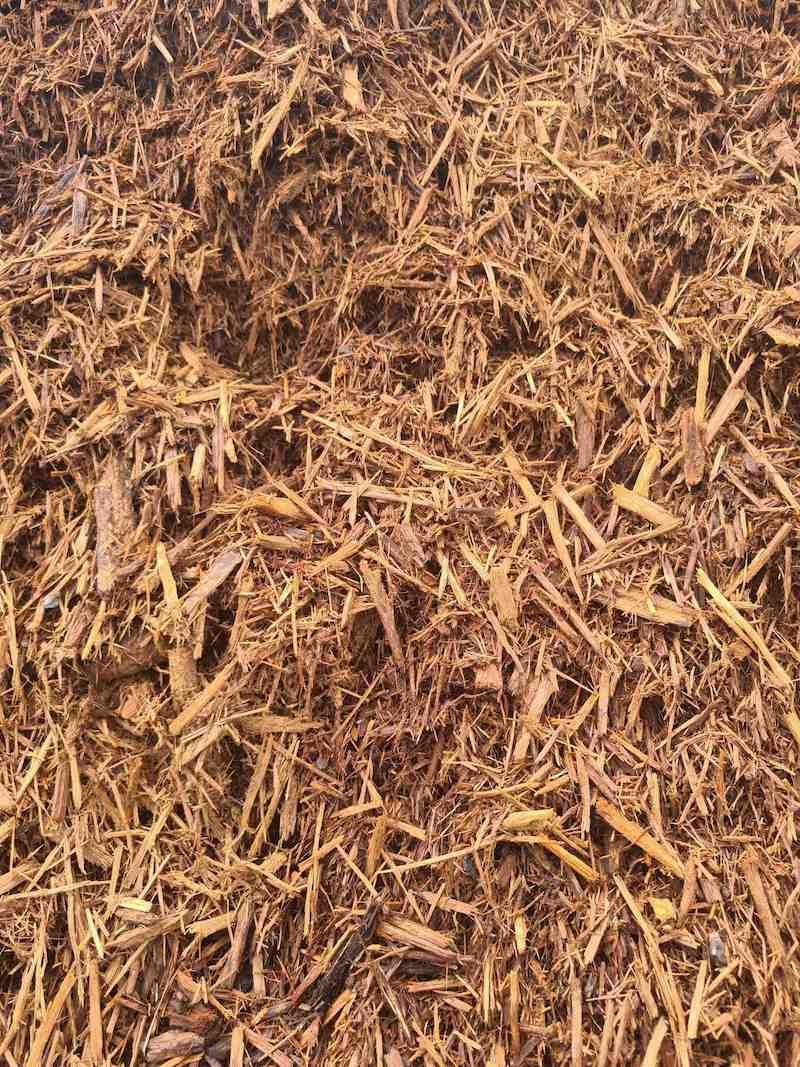 A Pile Of Brown Mulch Is Sitting On The Ground — Campbell's Truck and Bobcat and Landscape Supplies In Gympie, QLD