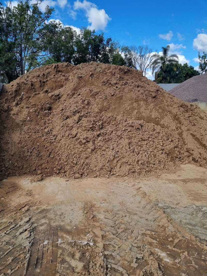 A Large Pile Of Dirt Is Sitting On Top Of A Dirt Field — Campbell's Truck and Bobcat and Landscape Supplies In Gympie, QLD