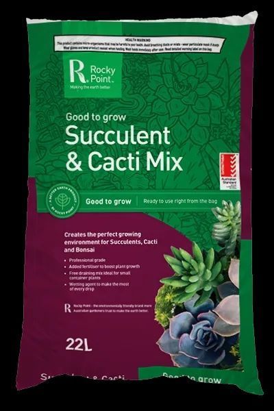 Boxes of sugar cane mulch are stacked on top of each other on a pallet.