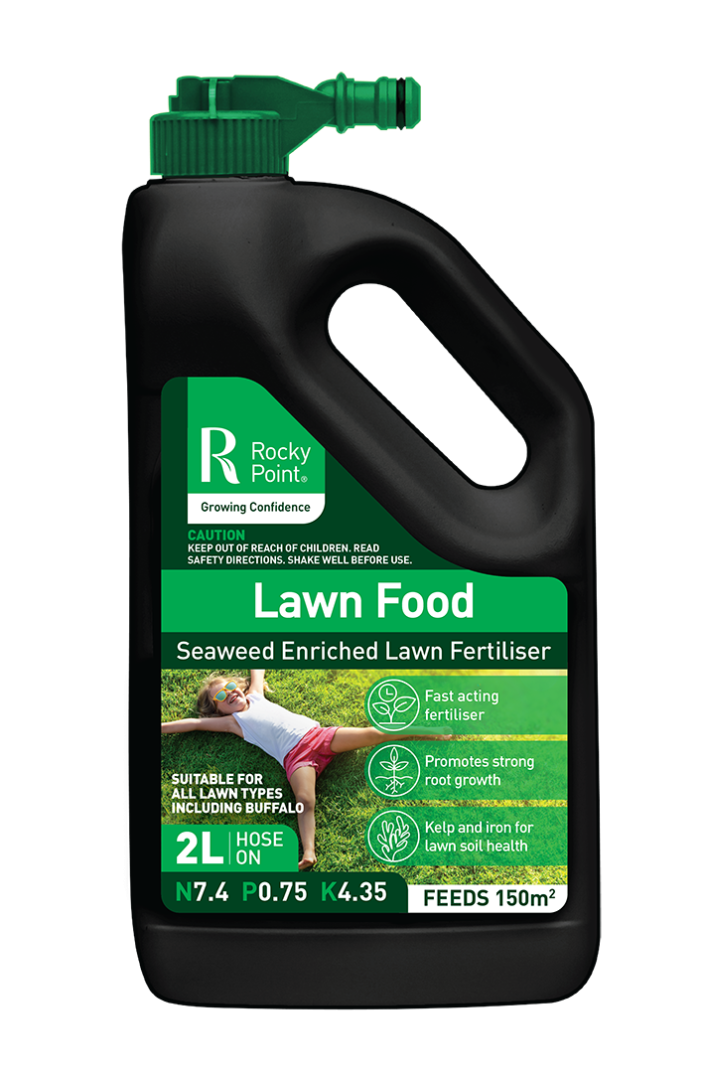 A bottle of lawn food with a hose attached to it.