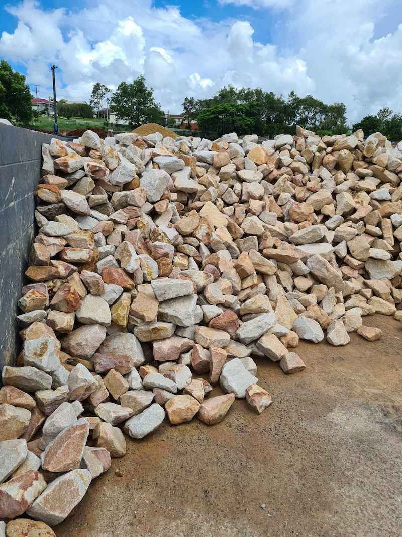 A Pile Of Rocks Sitting On Top Of A Dirt Field — Campbell's Truck and Bobcat and Landscape Supplies In Gympie, QLD