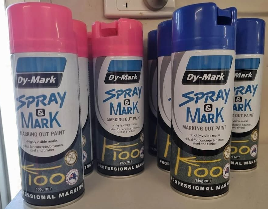 A Bunch Of Spray Paint Cans Are Sitting On A Table — Campbell's Truck and Bobcat and Landscape Supplies In Gympie, QLD