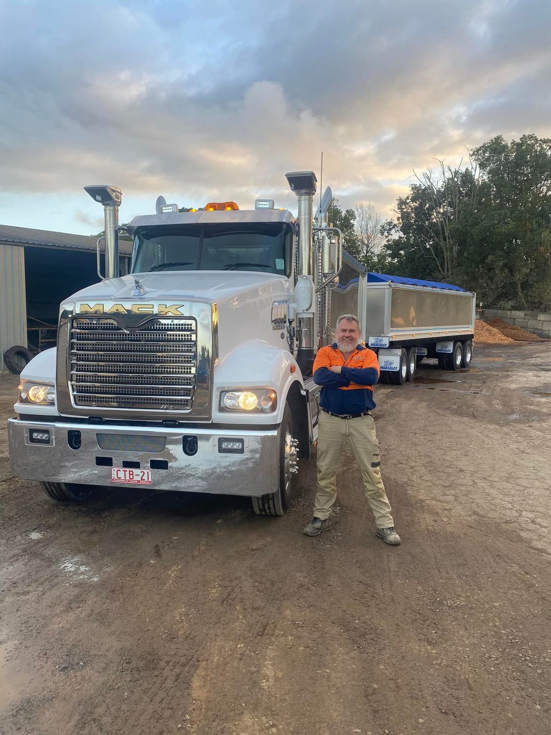 Two Dump Trucks Are Parked Next to Each Other in a Dirt Lot — Campbell's Truck and Bobcat and Landscape Supplies In Gympie, QLD