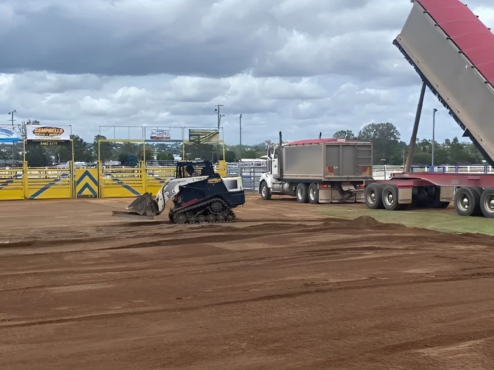 A Dump Truck Is Being Loaded With Dirt In A Field — Campbell's Truck and Bobcat and Landscape Supplies In Gympie, QLD