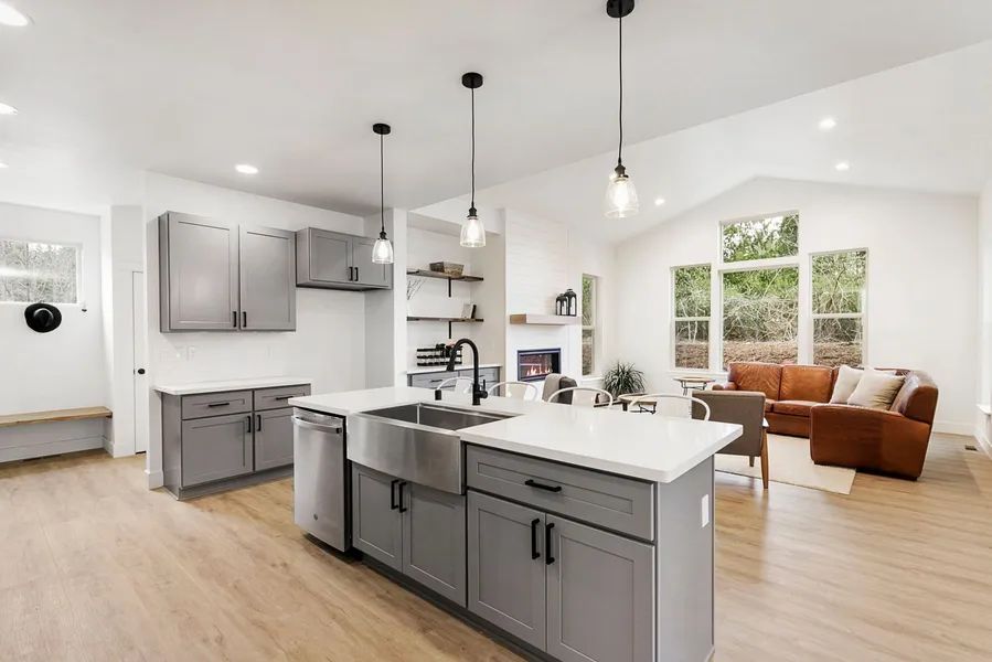 A kitchen with a large island and a sink in a house.