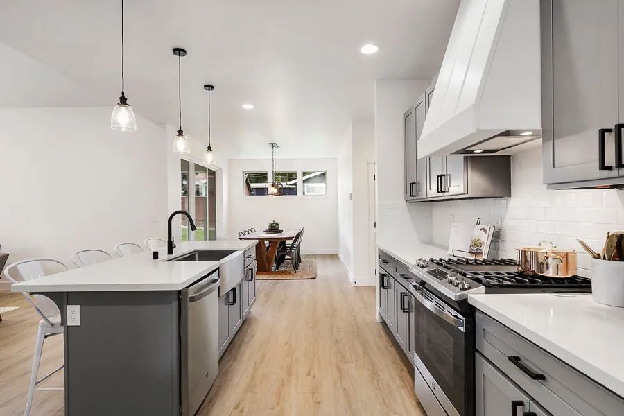 A kitchen with stainless steel appliances and a large island.