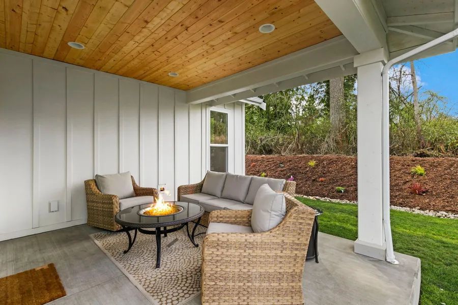 There is a fire pit on the porch of a house.
