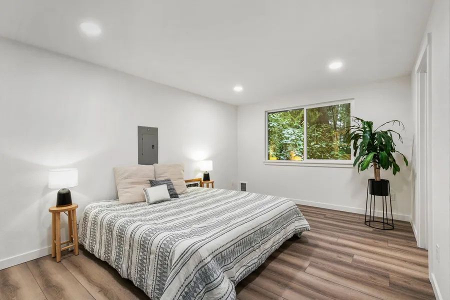 A bedroom with a large bed and a window.