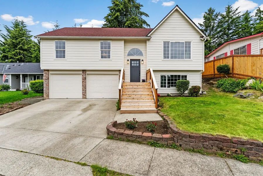 A large white house with stairs leading up to the front door