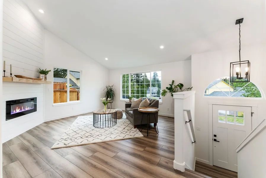 A living room with hardwood floors and a fireplace.