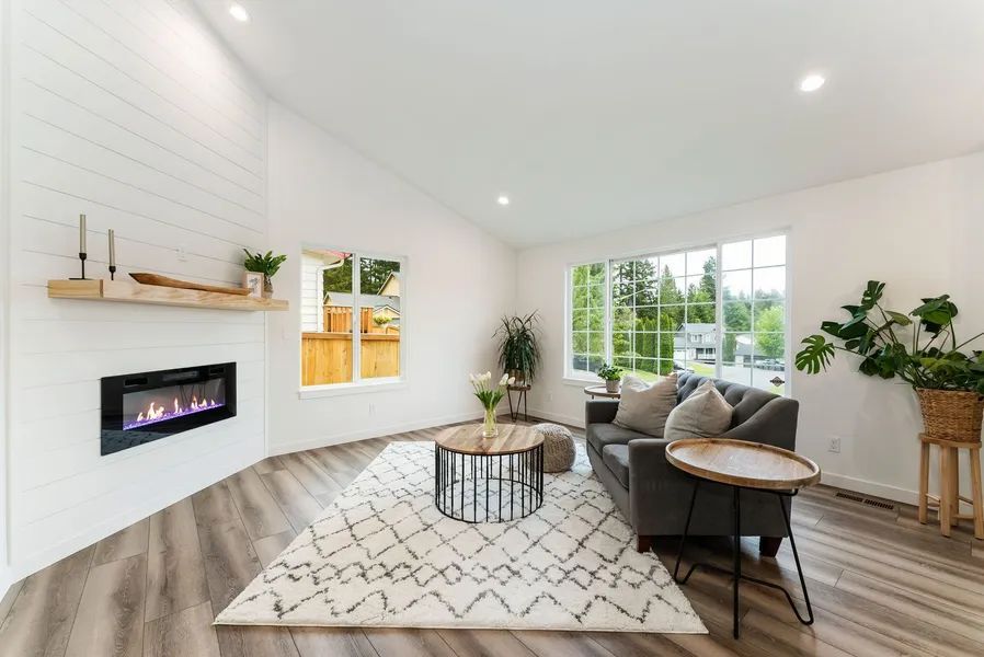 A living room with a fireplace , couch , table and rug.