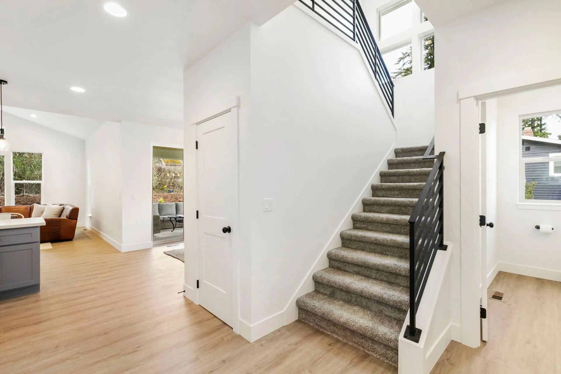 A hallway with stairs leading up to the second floor of a house.