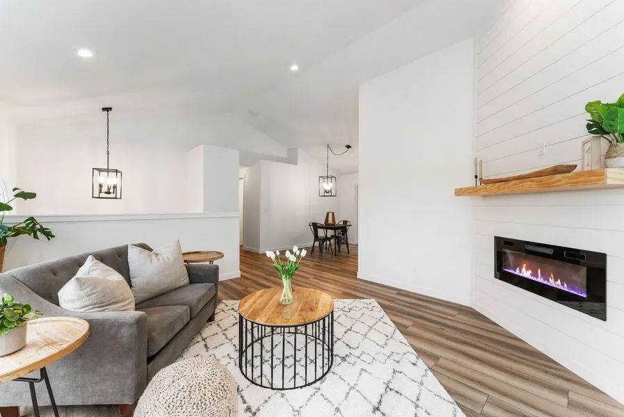 There is a fireplace in the corner of the living room.