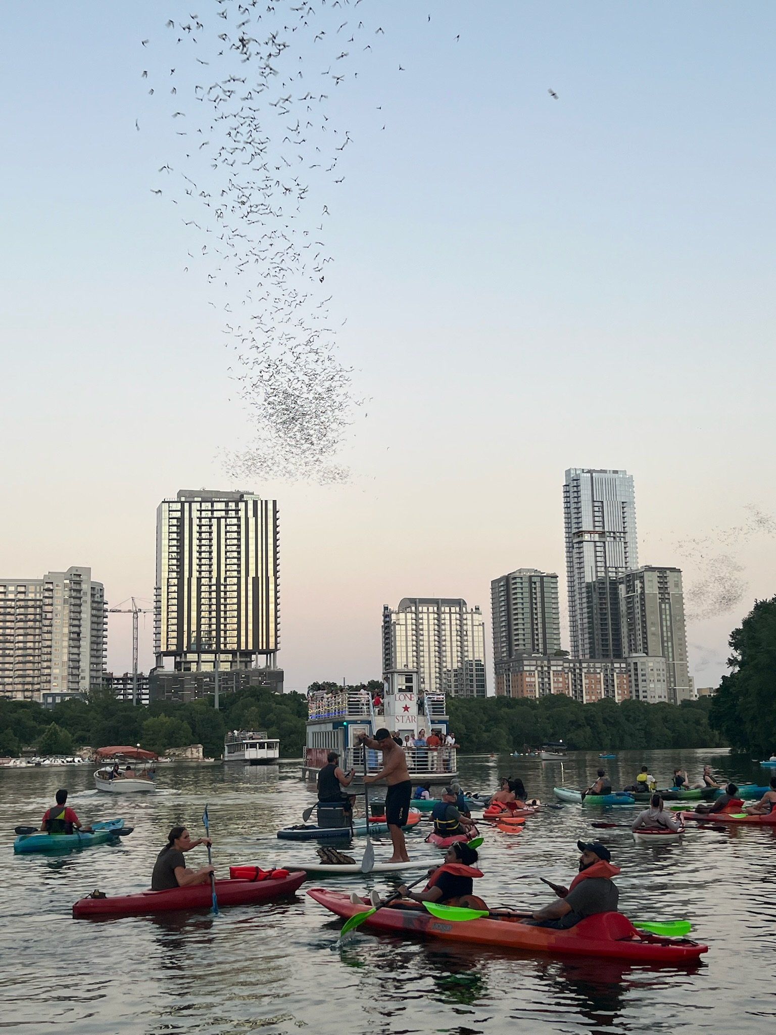 boats and bats kayak tour group watching the bats at sunset in Austin