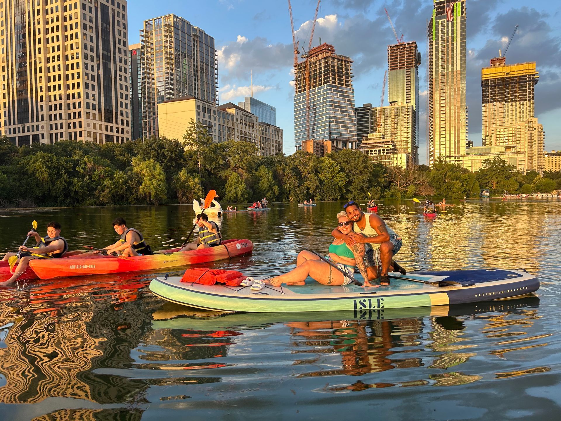 Paddle boarders dressed in appropriate water-resistant clothing, ready for a tour on Lady Bird Lake.