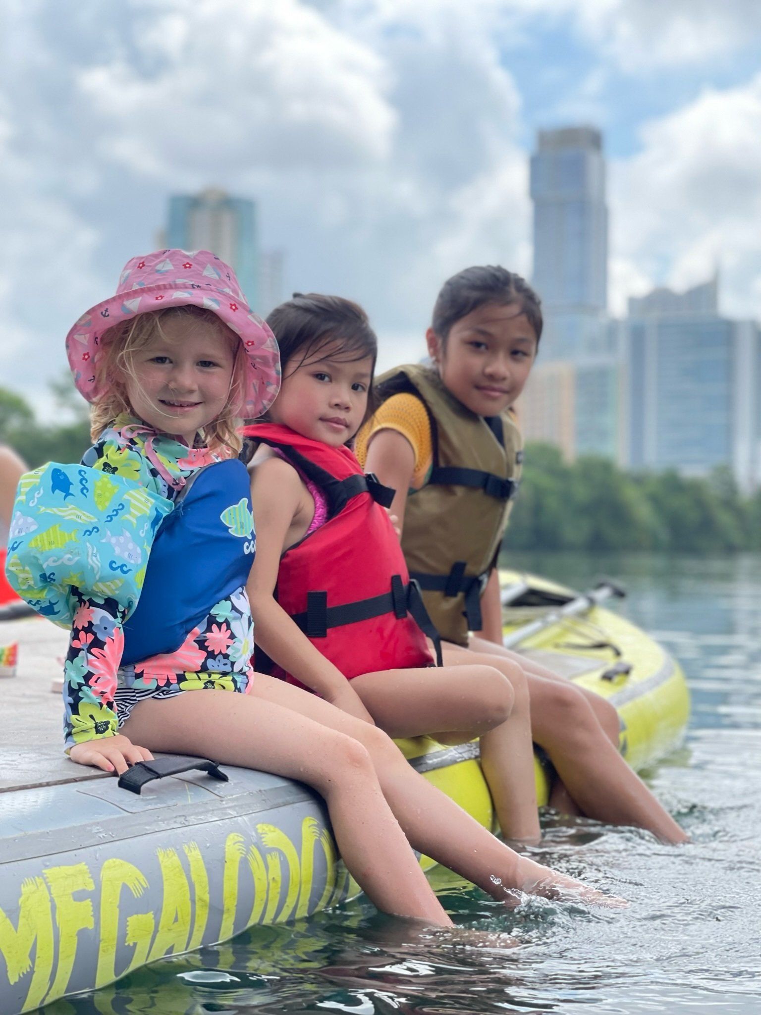 3 little girls on the giant paddle board tour in austin tx with boats and bats