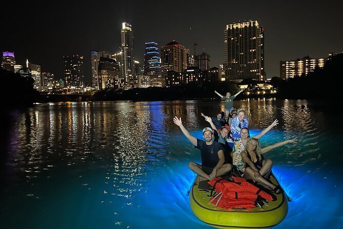 Paddleboards glowing underwater, having fun on lady bird lake looking at fish