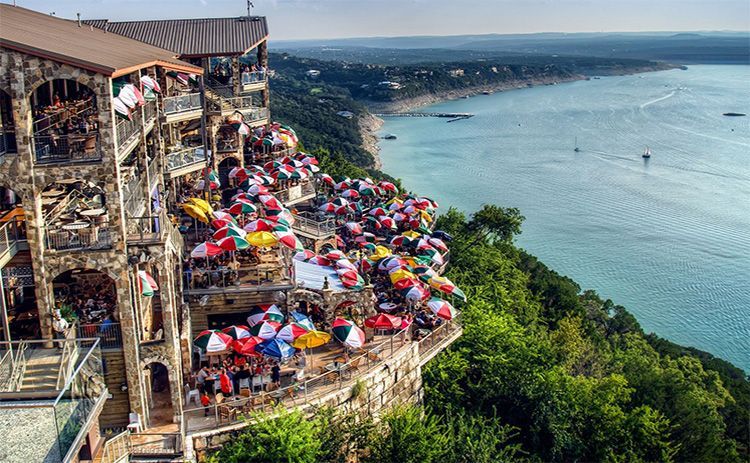 Sunset view from The Oasis on Lake Travis with diners enjoying their meals.