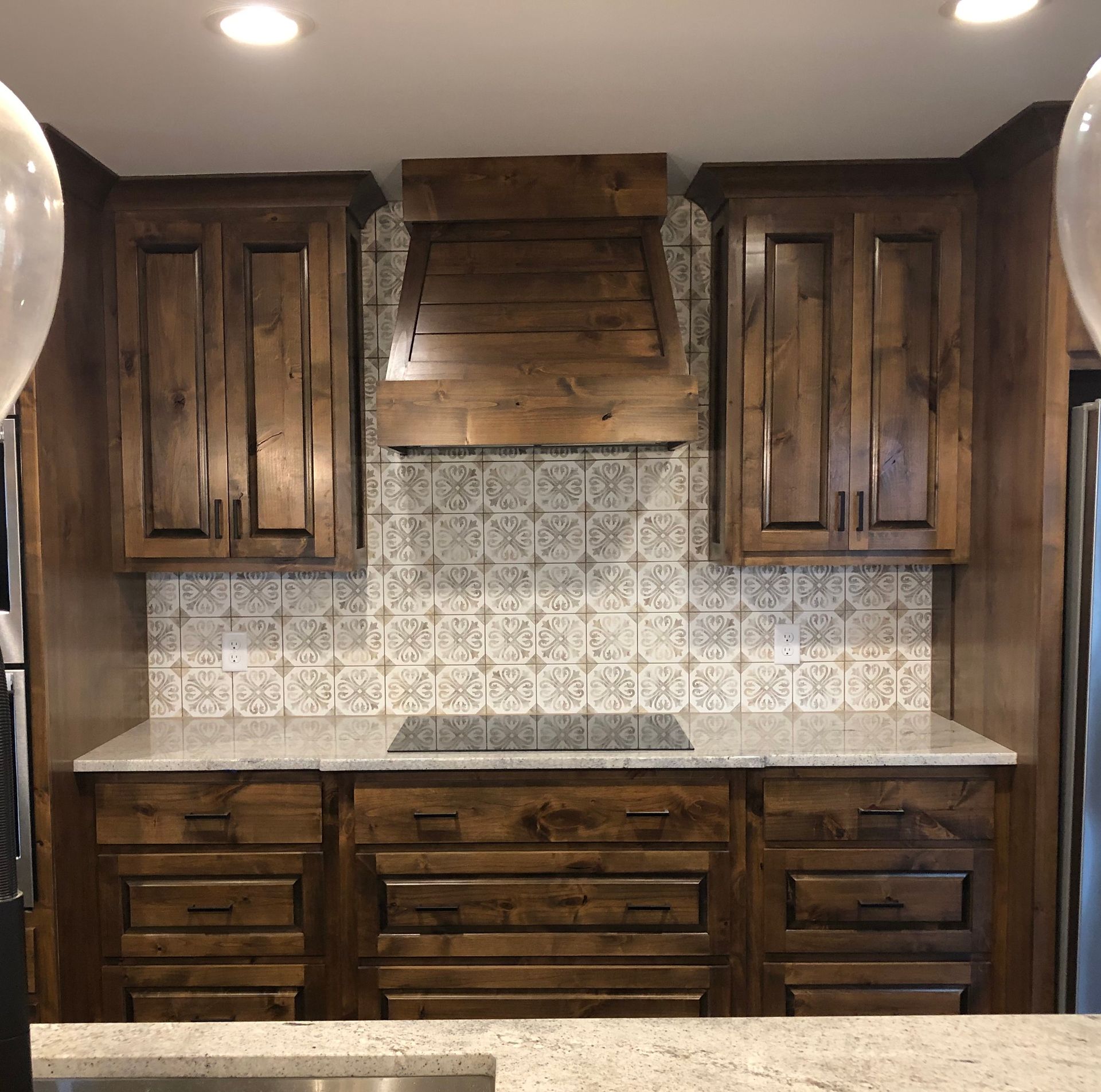 A kitchen with wooden cabinets and granite counter tops