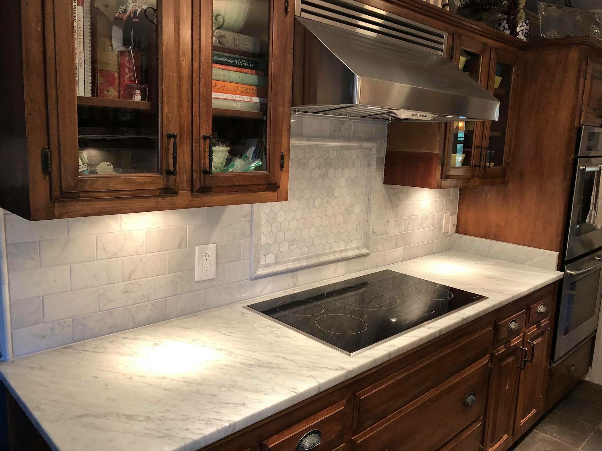 A kitchen with wooden cabinets and a stove top oven.