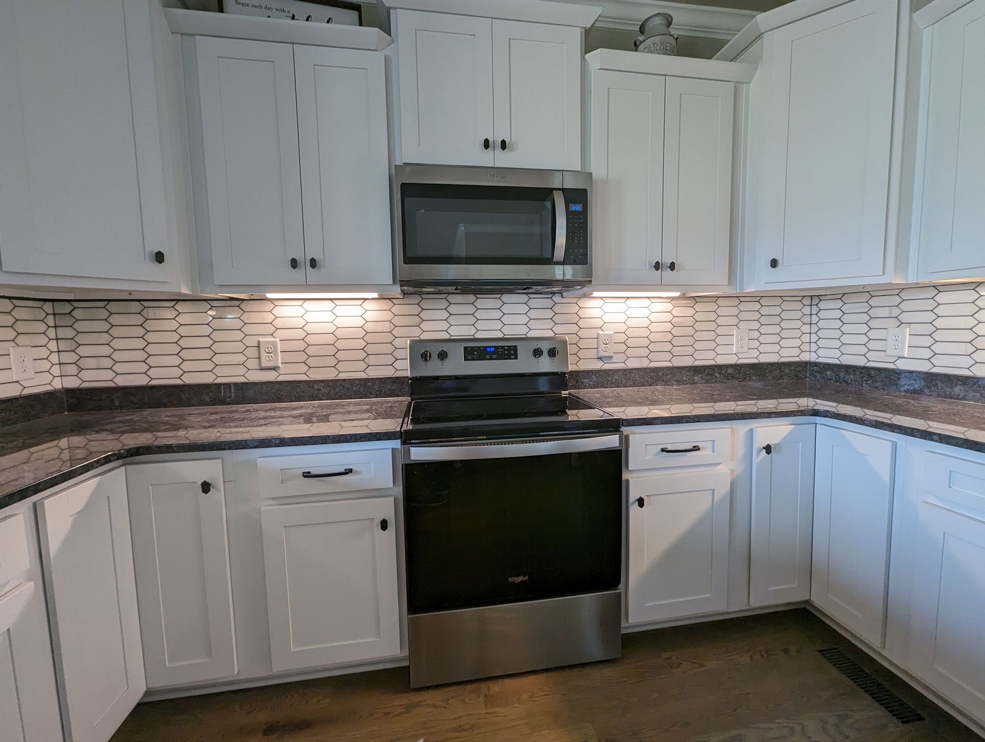 A kitchen with stainless steel appliances and white cabinets