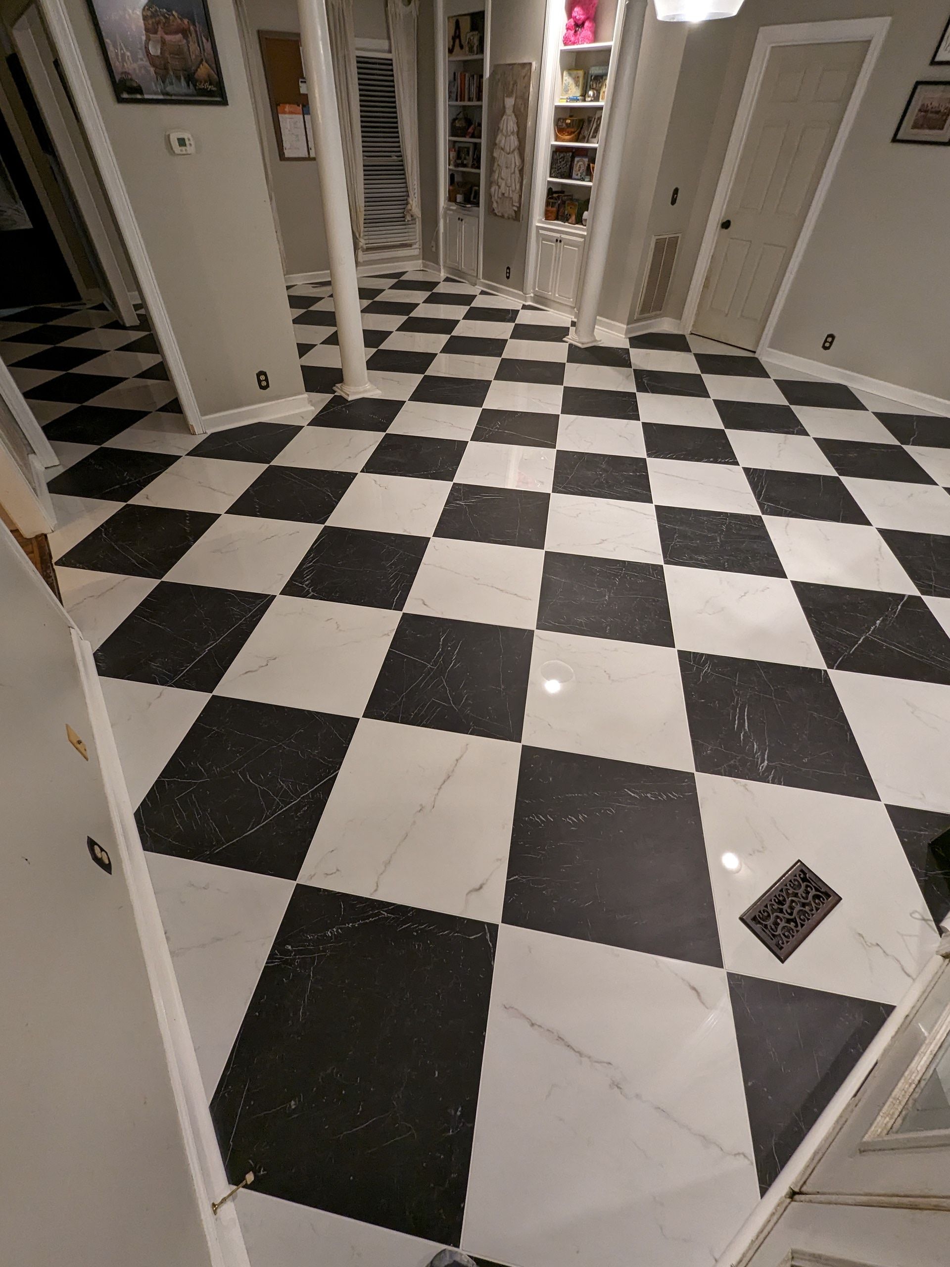 A black and white checkered floor in a hallway
