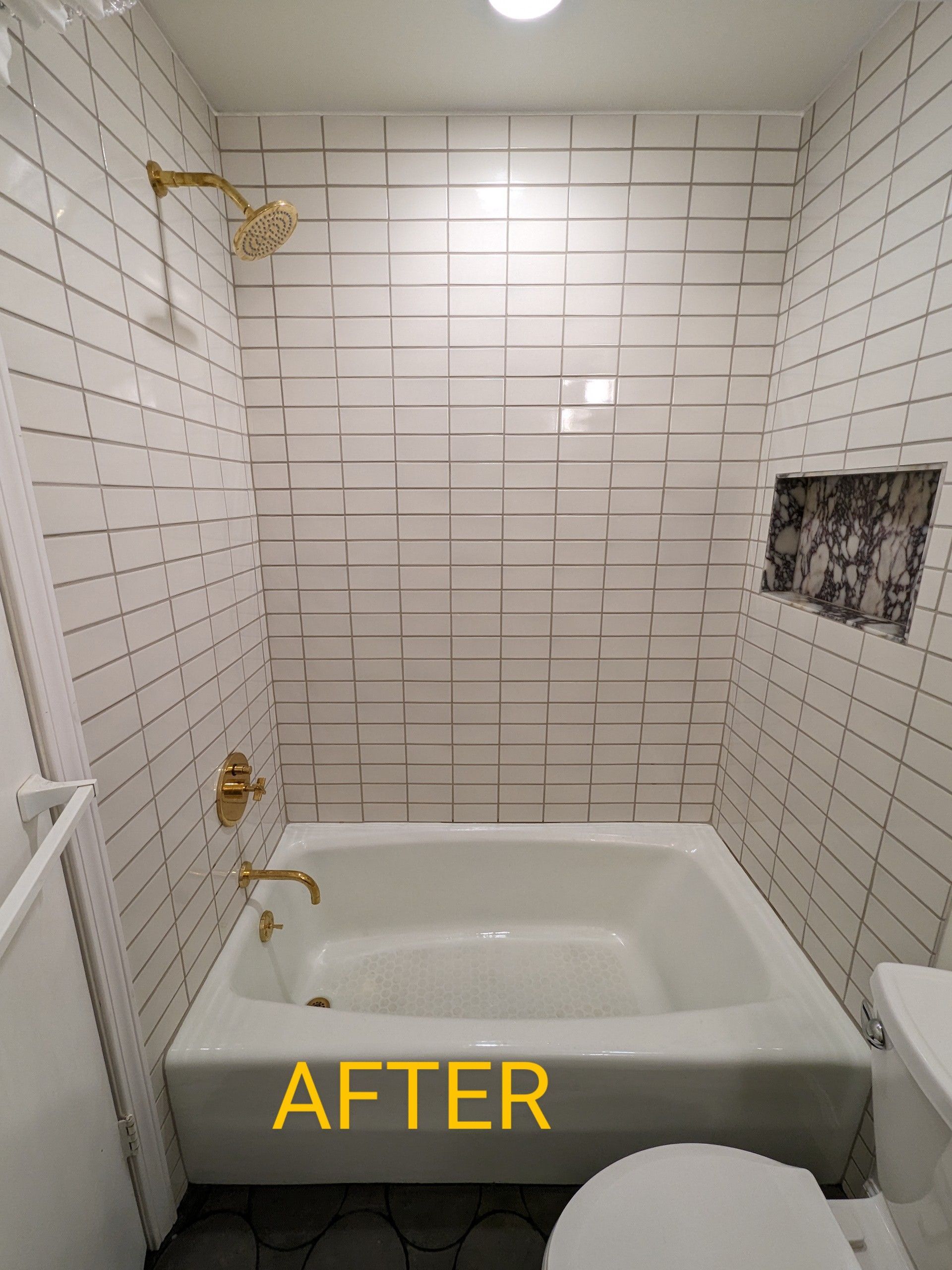 A bathroom with a bathtub , toilet and shower.