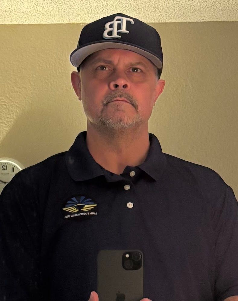 A black and white photo of an older man with a beard.