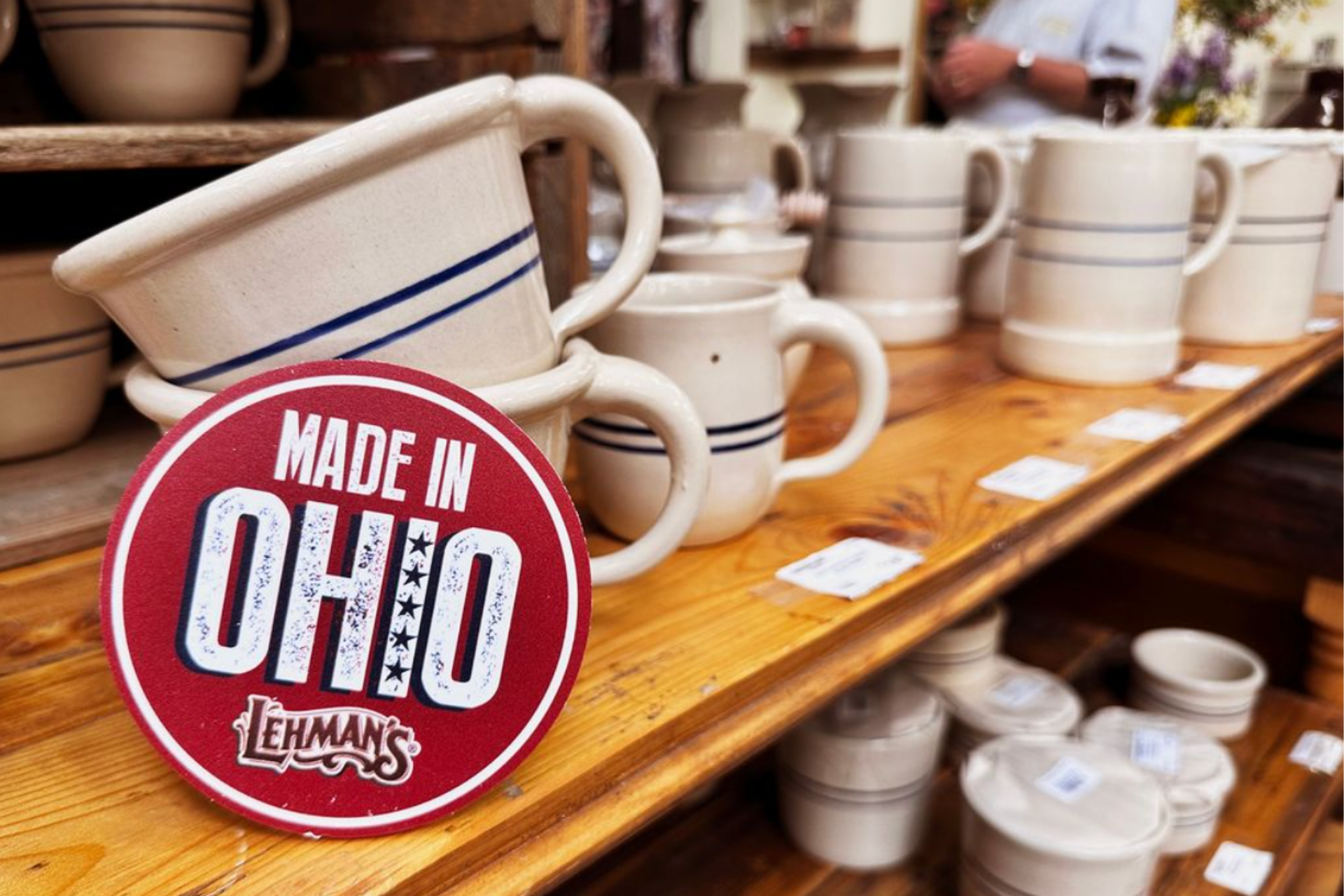 a shelf of crockery with a sign that says made in Ohio Lehman's