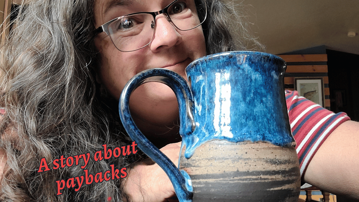 Woman with glasses holding a blue and brown mug; text: