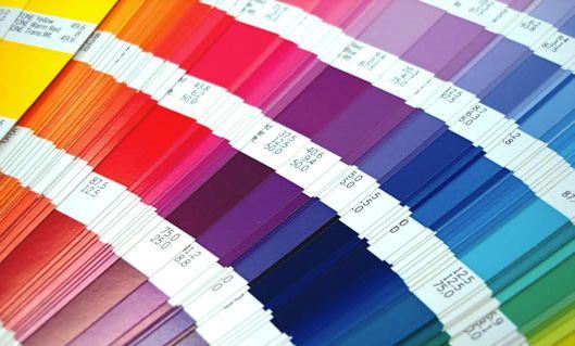 A bunch of different colored papers with numbers on them