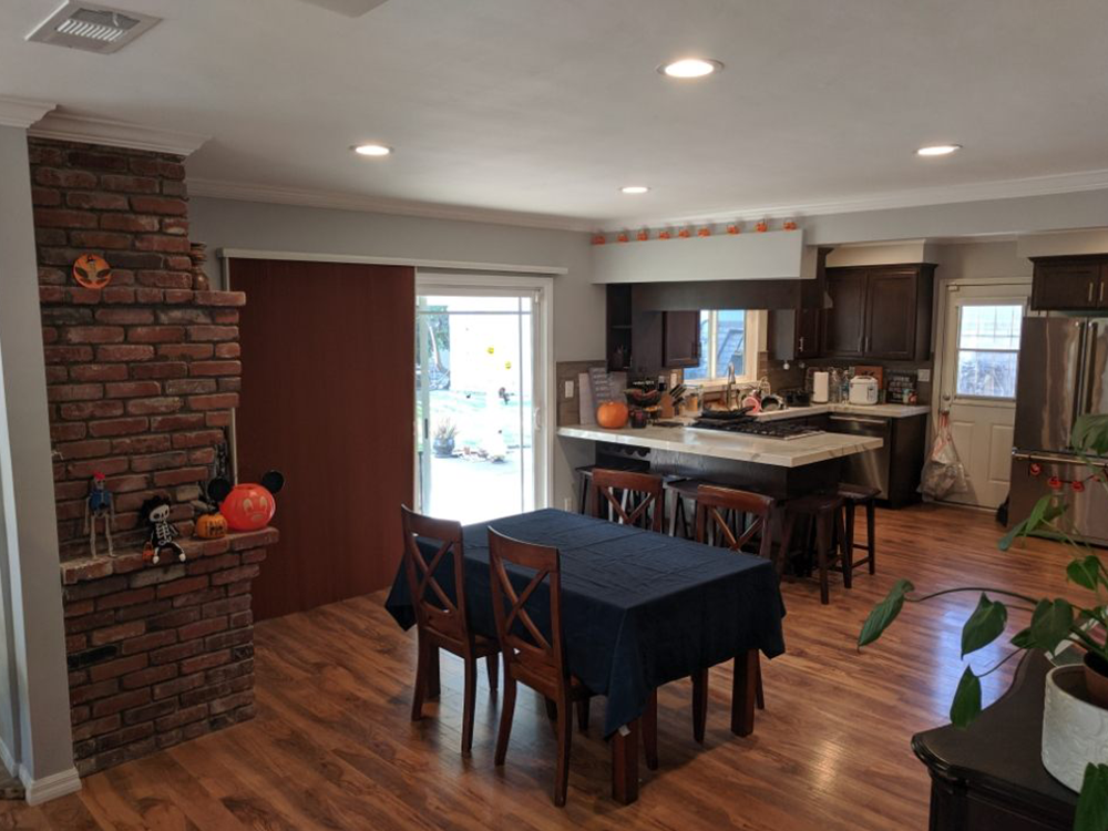 There is a table and chairs in the middle of the room.