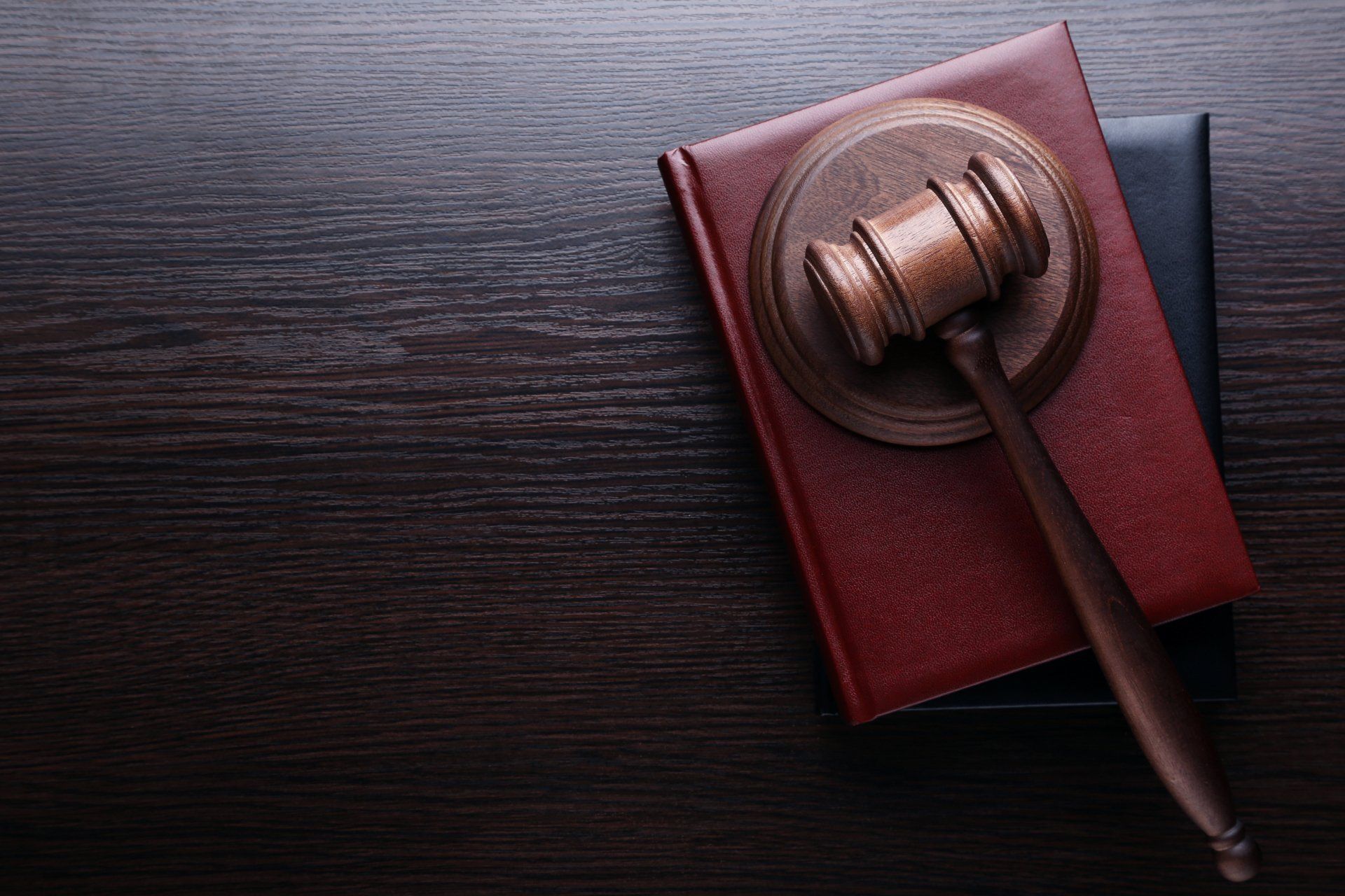 Judge gavel with books on wooden table