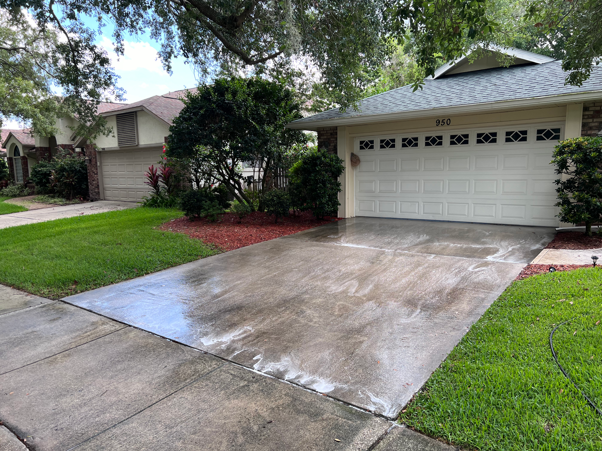 A driveway leading to a large white house