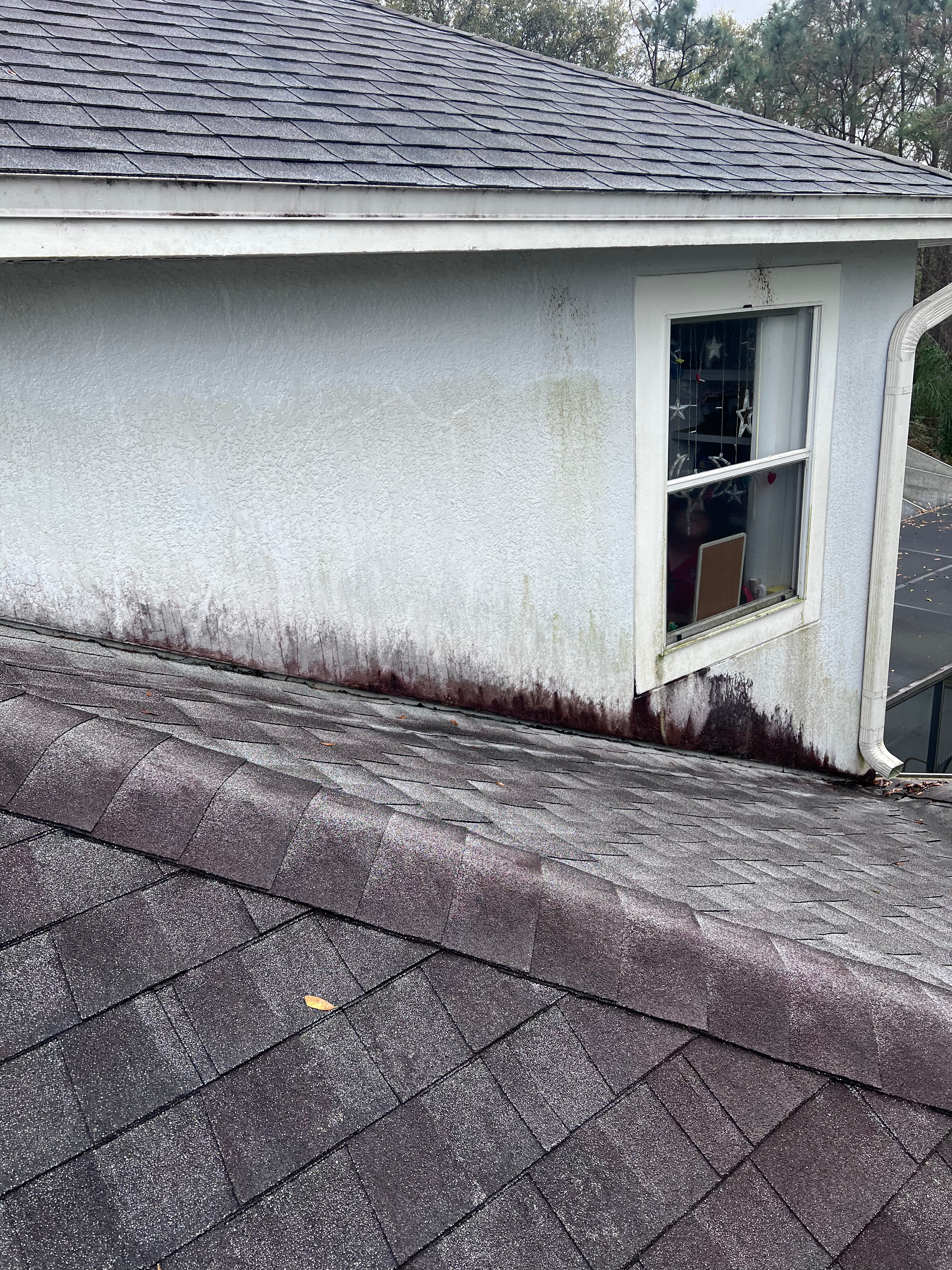 A house with a window on the side of it and a roof.