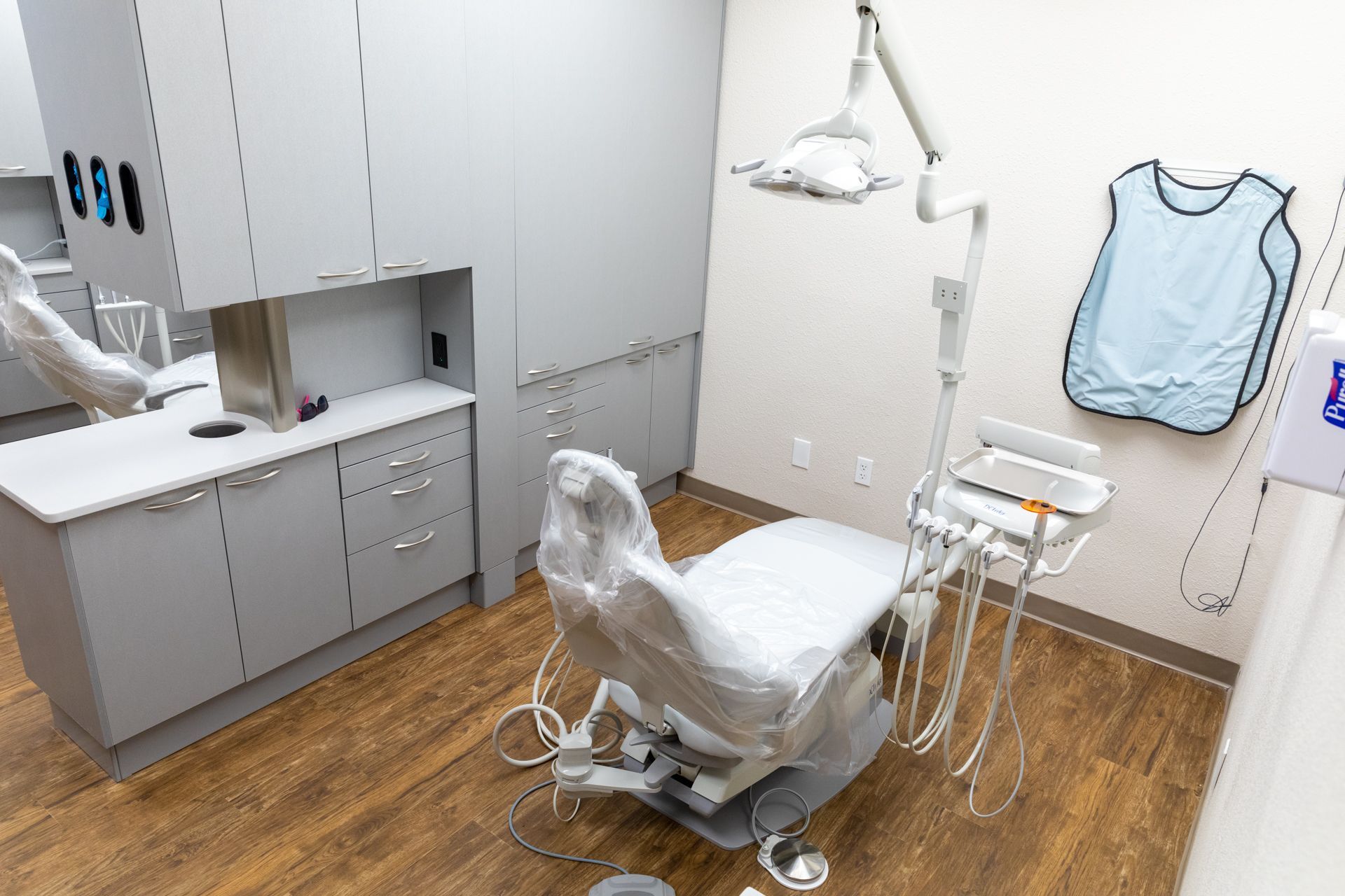 There is a dental chair in the middle of the room.