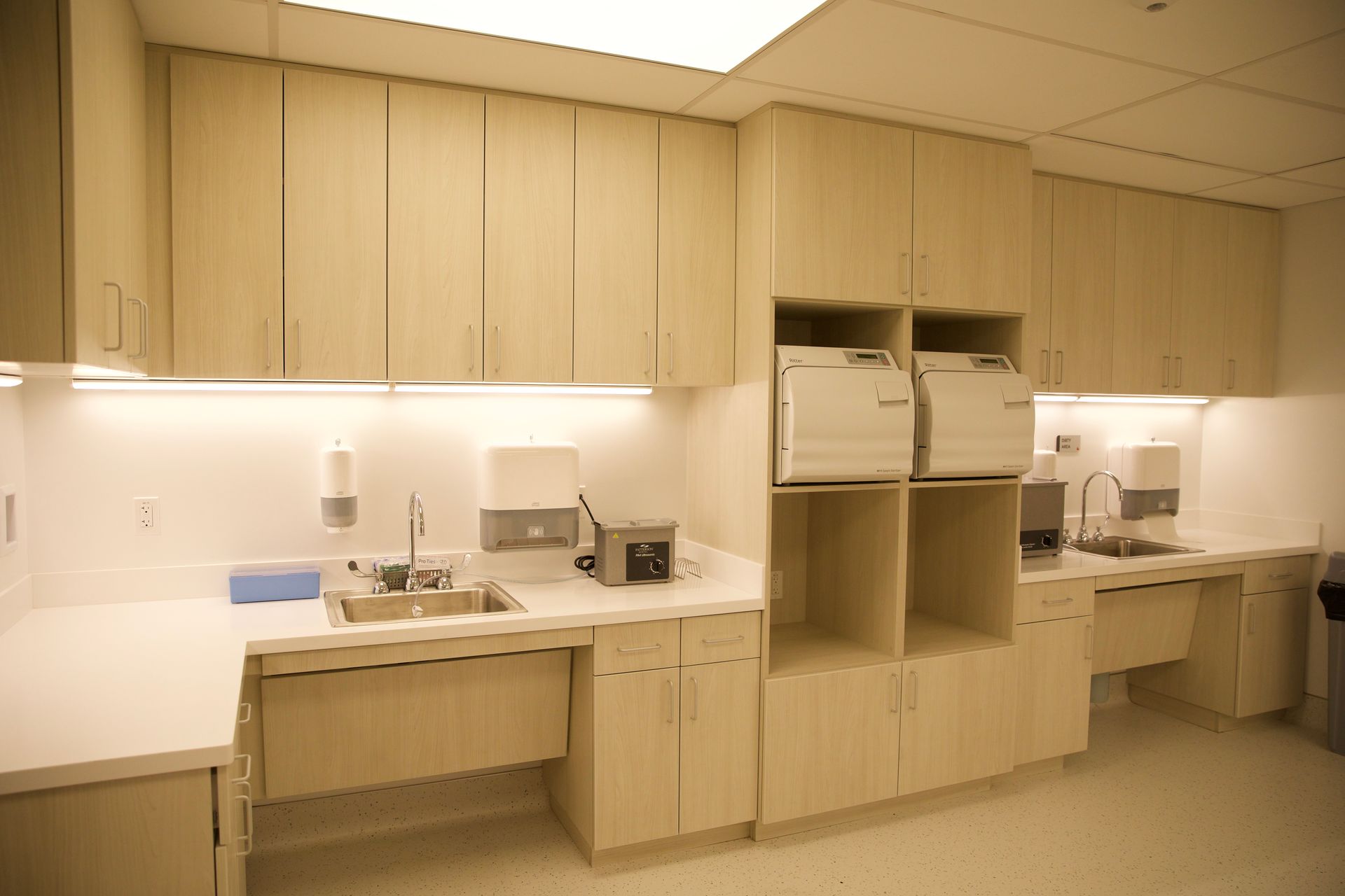 A kitchen with wooden cabinets and a sink