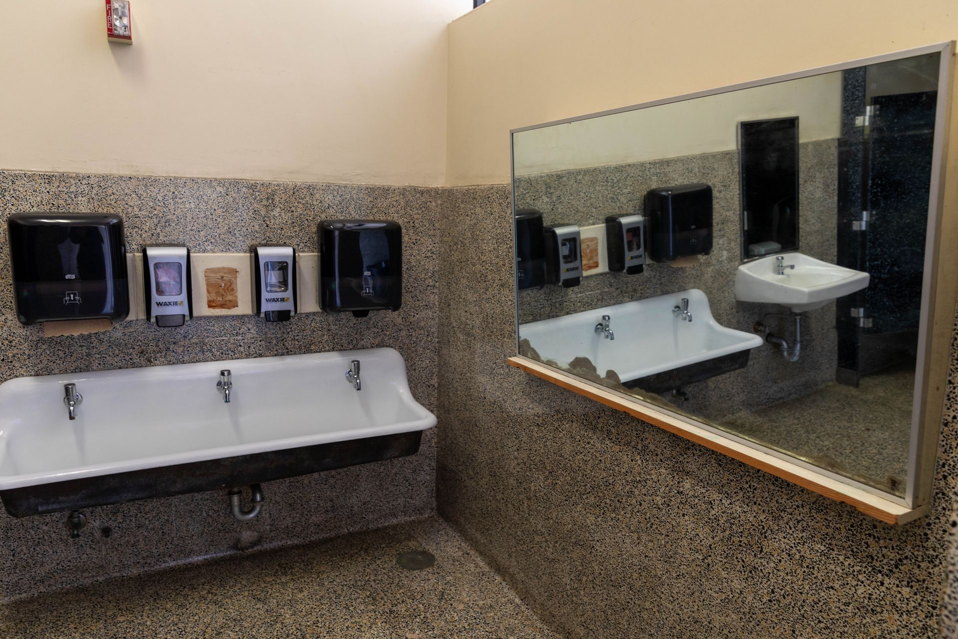 A bathroom with two sinks and a large mirror