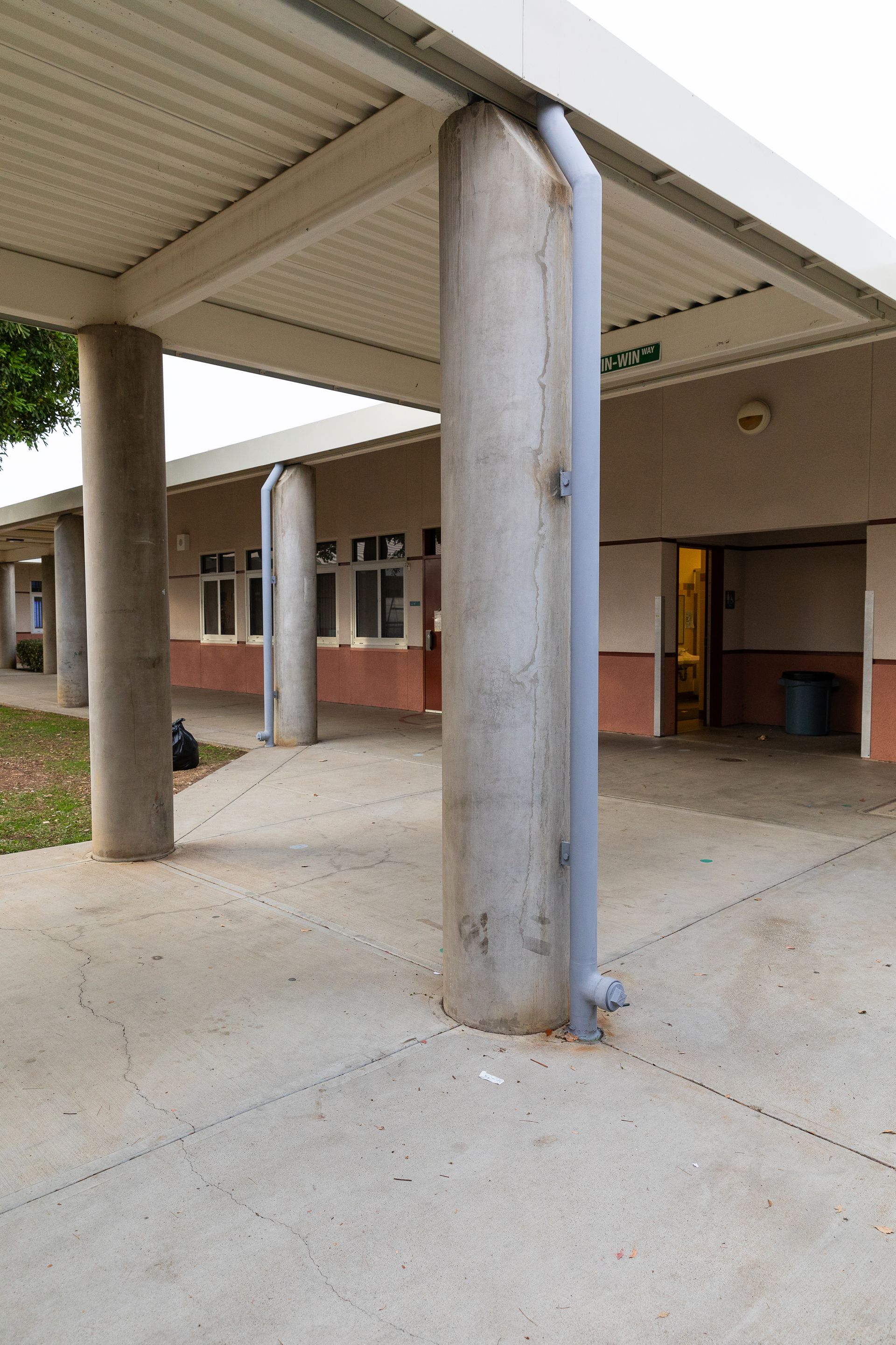 A building with columns and a covered walkway in front of it