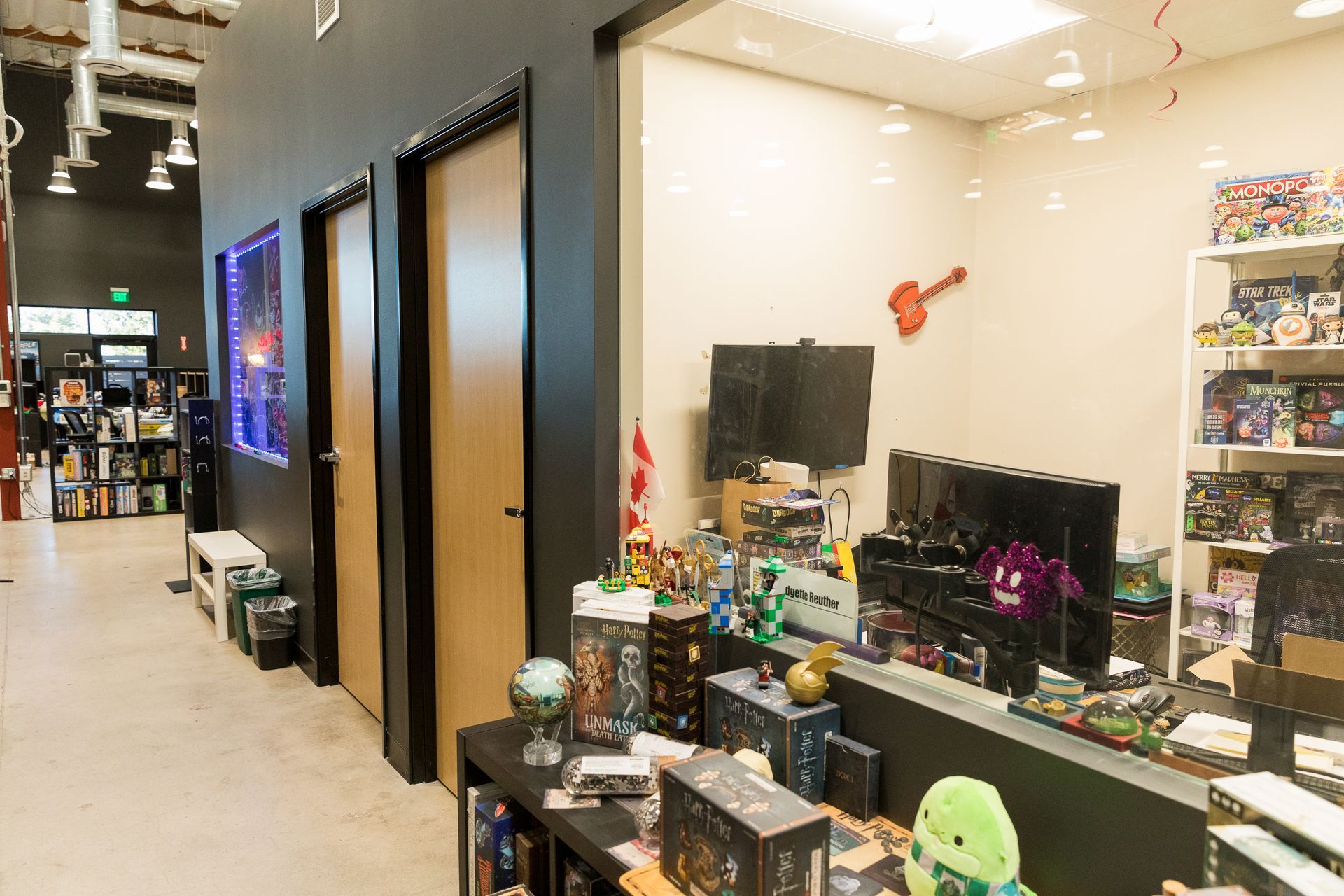 A room filled with lots of toys and a guitar on the wall.